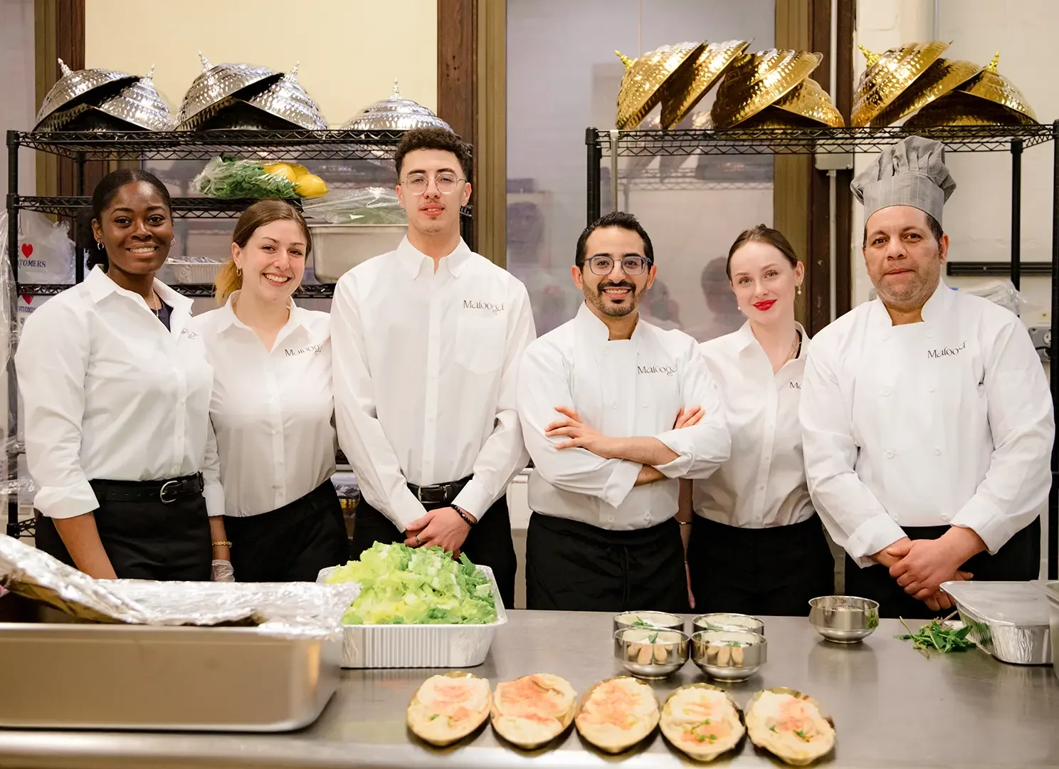 The Malooga restaurant team standing together in the kitchen